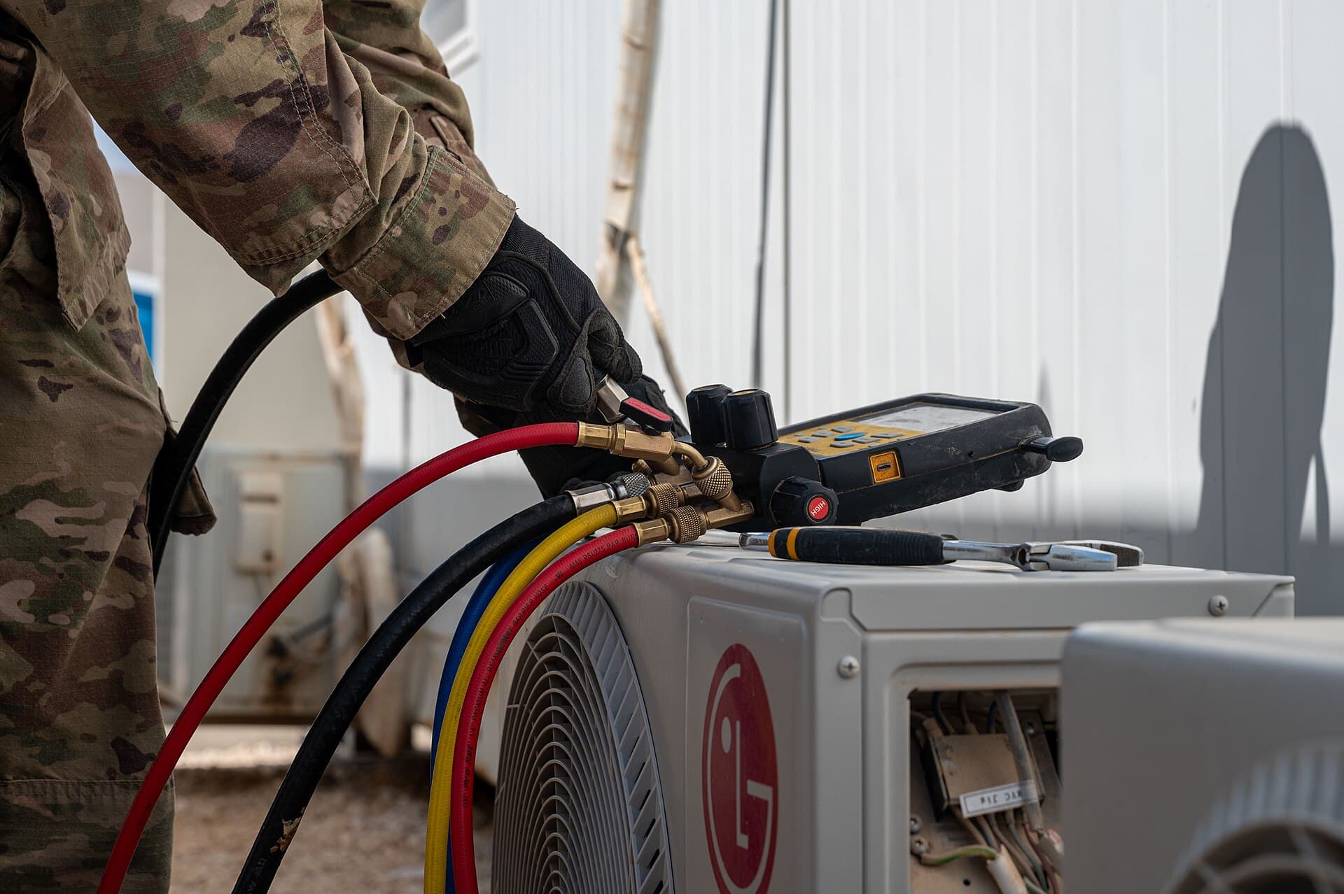 Manifold gauges connected to a split-system condenser during fault-finding