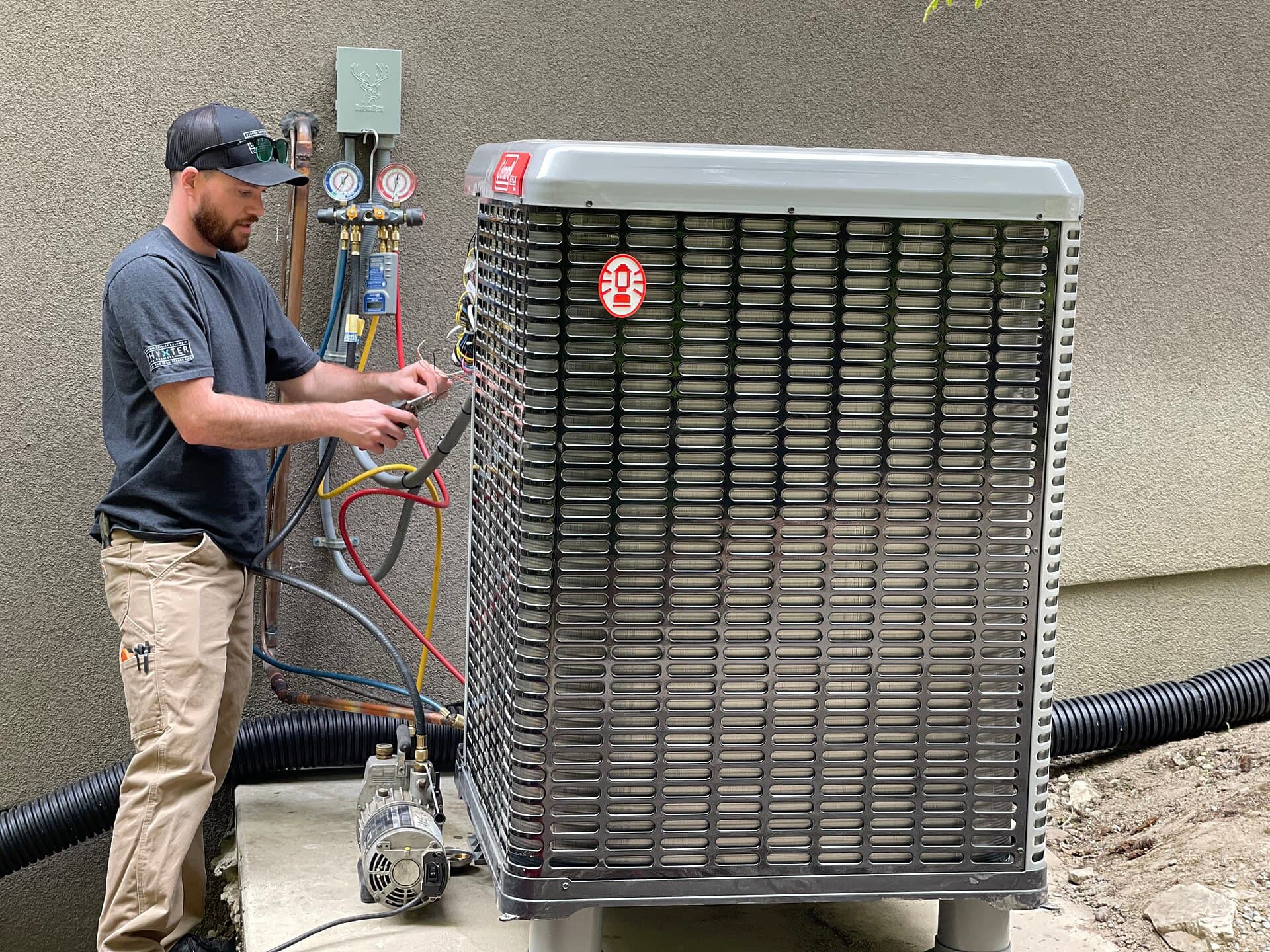 Technician connecting service gauges during a system commissioning